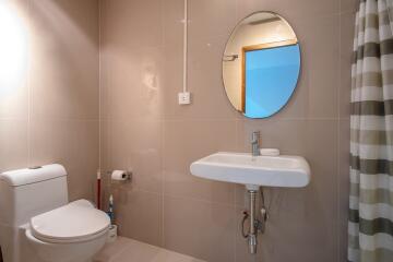 Modern bathroom with circular mirror and basin sink