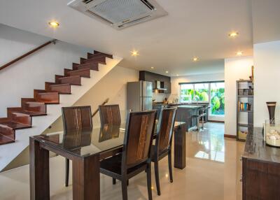 Modern open-plan dining area with adjacent kitchen