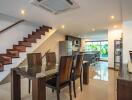 Modern open-plan dining area with adjacent kitchen