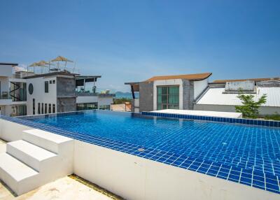 Outdoor view of a private swimming pool on a rooftop with surrounding buildings