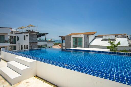 Outdoor view of a private swimming pool on a rooftop with surrounding buildings