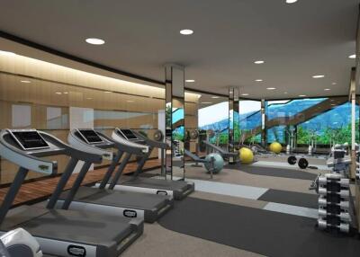 Modern gym with various equipment, including treadmills and weights