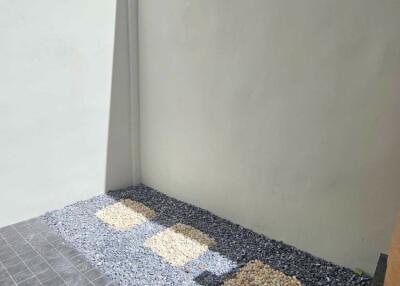 Outdoor area with gravel and tiled flooring