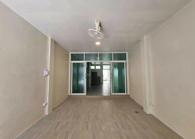 Empty living area with ceiling fan and tiled flooring