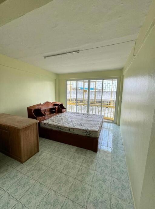 Spacious bedroom with large windows and natural light