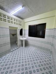 Bathroom with sink, mirror, window, and tiled walls and floor