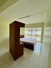 Spacious bedroom with large window and tiled floor