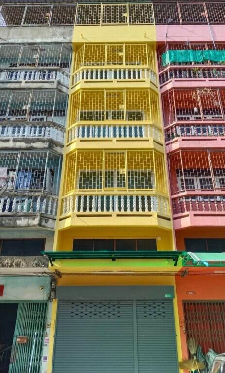 Colorful multi-story building with metal grilles