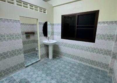 Image of a tiled bathroom with a sink and mirror