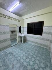 Image of a tiled bathroom with a sink and mirror