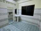 Image of a tiled bathroom with a sink and mirror