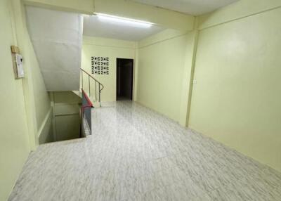 Bright hallway with tiled flooring and staircase