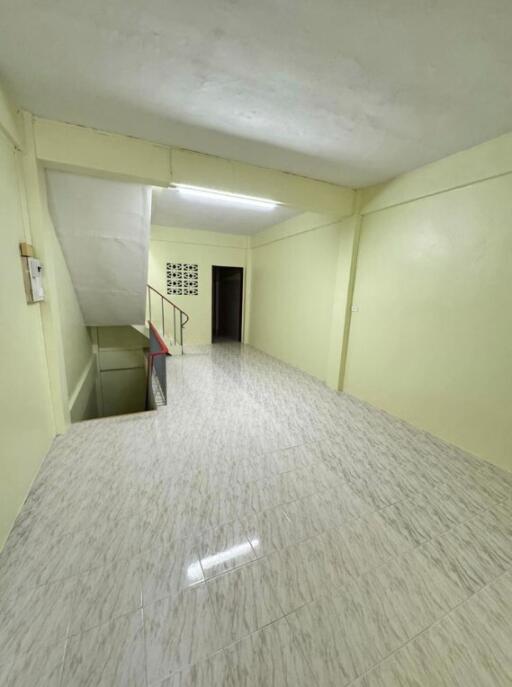 Bright hallway with tiled flooring and staircase