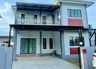 Two-story house with balcony and modern design