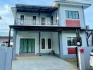 Two-story house with balcony and modern design