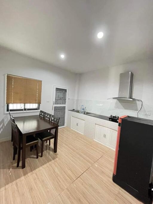 Modern kitchen with dining area and stainless steel appliances