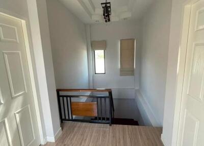 Well-lit hallway with a staircase