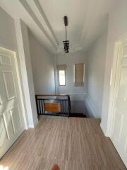 Well-lit hallway with a staircase