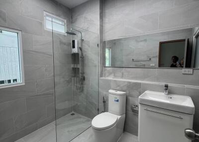 Contemporary bathroom with glass shower, toilet, and modern vanity