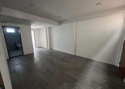 Spacious living room with tile flooring and recessed lighting