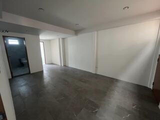 Spacious living room with tile flooring and recessed lighting