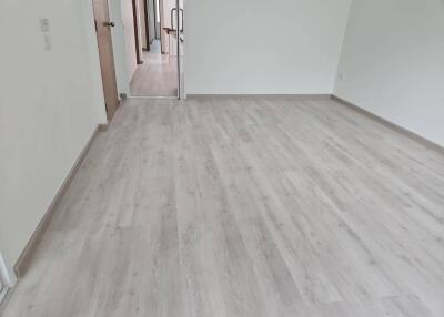 Spacious empty room with wooden flooring