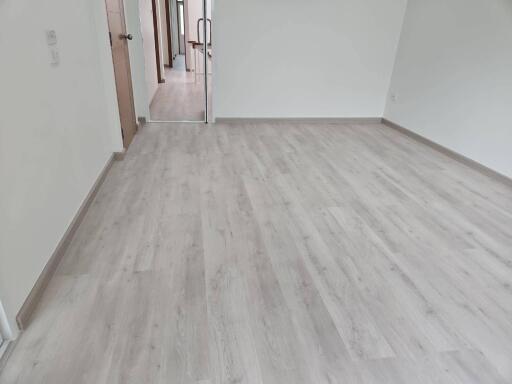 Spacious empty room with wooden flooring