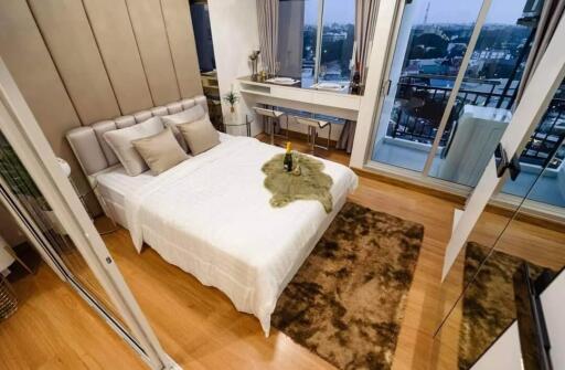 Modern bedroom with plush bedding and balcony view