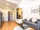 Modern living room with gray sofa and glass coffee table