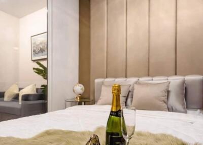 Luxurious bedroom with champagne bottle and plush fur throw on the bed