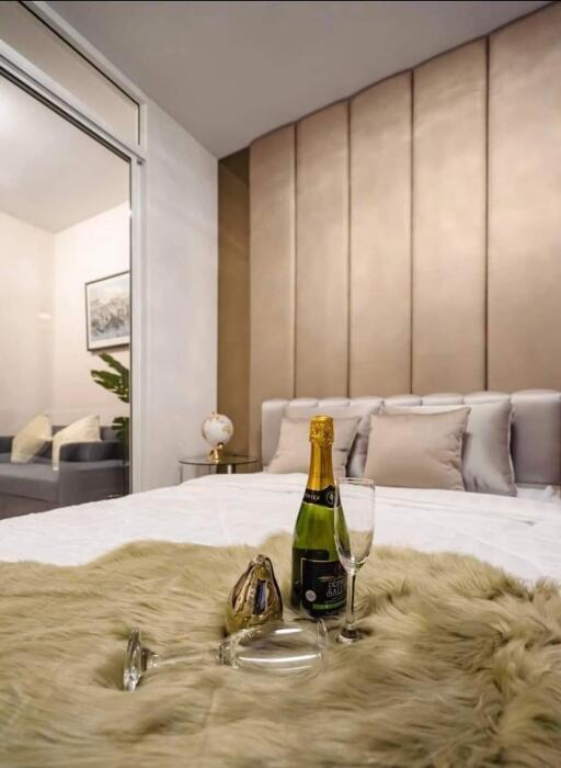 Luxurious bedroom with champagne bottle and plush fur throw on the bed