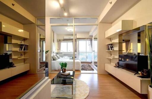 Modern living room with glass partitions leading to a bedroom