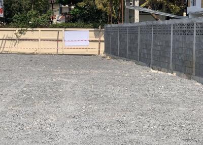 Empty lot with gravel and stone walls