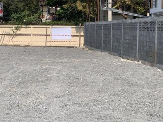 Empty lot with gravel and stone walls