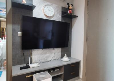 Modern living room with a wall-mounted TV and air conditioning