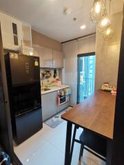 Modern kitchen with sleek appliances and a dining table