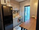 Modern kitchen with sleek appliances and a dining table