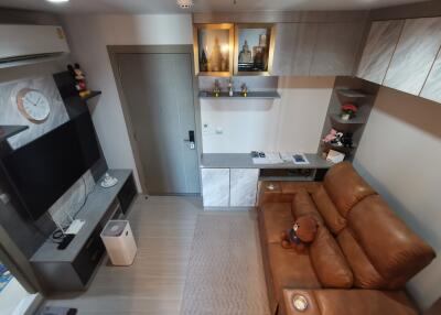 Modern living room with brown leather couch and mounted TV