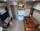 Modern living room with brown leather couch and mounted TV