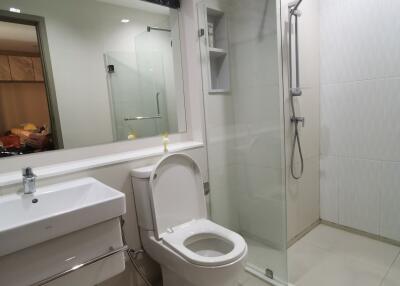 Modern bathroom with glass shower enclosure and vanity