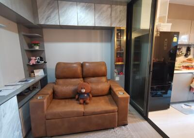 Cozy living room with a leather sofa and sliding glass door