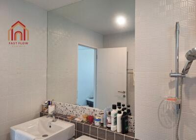 Modern bathroom with sink, large mirror, and shower