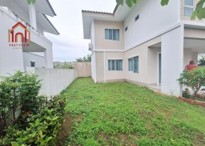 Exterior view of a two-story house with garden