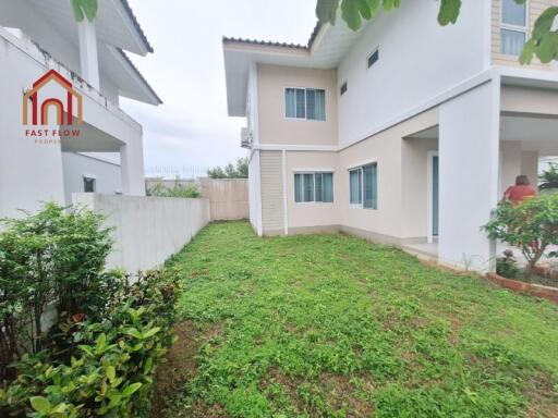 Exterior view of a two-story house with garden