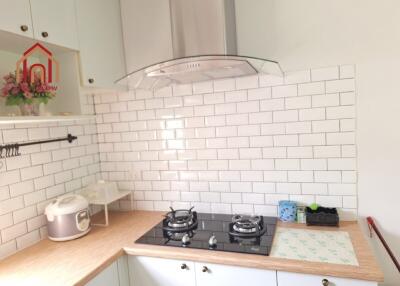 Modern kitchen with gas stove and white subway tile backsplash