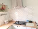 Modern kitchen with gas stove and white subway tile backsplash