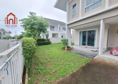 View of the garden and exterior of a two-story home