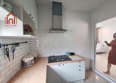 Modern kitchen with white cabinets and tiled backsplash