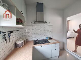 Modern kitchen with white cabinets and tiled backsplash