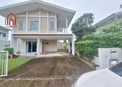 Front view of a two-story house with a driveway and front lawn